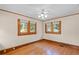 Empty bedroom with hardwood floors and three windows at 806 E Amelia St, Orlando, FL 32803