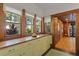 Bright breakfast nook with wood trim, built-in cabinets, and multiple windows at 806 E Amelia St, Orlando, FL 32803