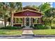 Charming home with a brick exterior, complemented by lush landscaping and a mature palm tree at 806 E Amelia St, Orlando, FL 32803