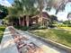 Charming home with well-manicured lawn, mature trees, and a brick walkway leading to the front at 806 E Amelia St, Orlando, FL 32803