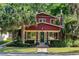 Charming home with a brick exterior, complemented by lush landscaping and a mature palm tree at 806 E Amelia St, Orlando, FL 32803