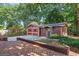 Charming red garage with ample parking space, surrounded by lush greenery and mature trees at 806 E Amelia St, Orlando, FL 32803