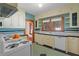 Bright kitchen with tile countertops, white appliances, and ample cabinet space at 806 E Amelia St, Orlando, FL 32803