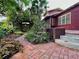 Inviting brick walkway with lush landscaping, mature trees, and a charming water fountain at 806 E Amelia St, Orlando, FL 32803