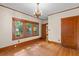 Bright room with hardwood floors, three large windows, and natural wood trim at 806 E Amelia St, Orlando, FL 32803