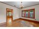 Charming living room with hardwood floors, wood trim, and decorative chandelier at 806 E Amelia St, Orlando, FL 32803