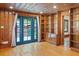 Inviting living room with wood paneling, built-in bookshelves, and French doors at 806 E Amelia St, Orlando, FL 32803