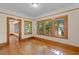 Bright room with hardwood floors, three large windows, and natural wood trim at 806 E Amelia St, Orlando, FL 32803