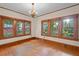 Bright room with hardwood floors, three large windows, and natural wood trim at 806 E Amelia St, Orlando, FL 32803