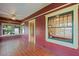 Cozy sunroom features brick floors, ceiling fan, and lots of natural light at 806 E Amelia St, Orlando, FL 32803
