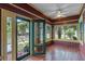 Cozy sunroom features brick floors, ceiling fan, and lots of natural light at 806 E Amelia St, Orlando, FL 32803