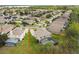 Aerial view of home with pool and spa in fenced backyard in a lush community at 812 Seneca Meadows Rd, Winter Springs, FL 32708