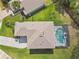 Aerial view of the home featuring a large pool, patio, and well-manicured lawn at 812 Seneca Meadows Rd, Winter Springs, FL 32708