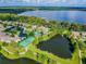 Stunning aerial view of the community showcasing the lake, tennis courts, and pool at 812 Seneca Meadows Rd, Winter Springs, FL 32708