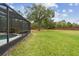 Expansive backyard featuring lush grass, mature tree, and brick perimeter fencing at 812 Seneca Meadows Rd, Winter Springs, FL 32708