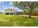 Large backyard featuring lush lawn, a screened-in pool, and mature trees, ideal for outdoor activities and relaxation at 812 Seneca Meadows Rd, Winter Springs, FL 32708