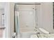Clean bathroom with a shower-tub combo, white tile, and granite countertop vanity at 812 Seneca Meadows Rd, Winter Springs, FL 32708