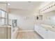 Well-lit bathroom featuring a double vanity, tiled flooring, and framed mirrors, offering a clean and functional space at 812 Seneca Meadows Rd, Winter Springs, FL 32708