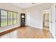 Inviting bedroom features wood floors, a window with natural light, and an ensuite bathroom at 812 Seneca Meadows Rd, Winter Springs, FL 32708