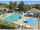 Community pool with chairs and splashpad with blue overhead umbrella at 812 Seneca Meadows Rd, Winter Springs, FL 32708