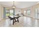 Bright dining area boasts tile flooring, a decorative light fixture, and a view of the outdoors at 812 Seneca Meadows Rd, Winter Springs, FL 32708