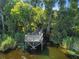 Dock surrounded by greenery going to a body of water at 812 Seneca Meadows Rd, Winter Springs, FL 32708