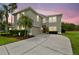 Stunning two-story home with a well-manicured lawn, lush landscaping, and a red front door at 812 Seneca Meadows Rd, Winter Springs, FL 32708