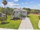 Beautiful two-story home featuring a well-kept lawn, mature trees, and a long driveway at 812 Seneca Meadows Rd, Winter Springs, FL 32708