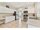 Well-equipped kitchen featuring stainless steel appliances, white cabinetry, and tile flooring at 812 Seneca Meadows Rd, Winter Springs, FL 32708