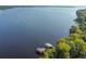 Aerial shot of lake with two docks surrounded by green trees at 812 Seneca Meadows Rd, Winter Springs, FL 32708