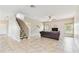 Cozy living room with a staircase, neutral walls, tile floors, and an open layout at 812 Seneca Meadows Rd, Winter Springs, FL 32708