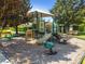 Community playground with green frog spring rider and benches at 812 Seneca Meadows Rd, Winter Springs, FL 32708