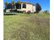 Expansive green lawn behind home with an outdoor trampoline and mature landscaping at 8250 Cherry Lake Rd, Groveland, FL 34736