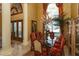Elegant dining room with large windows, decorative columns, and formal furnishings at 8250 Cherry Lake Rd, Groveland, FL 34736
