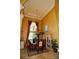 Elegant dining room with tall ceilings, decorative chandelier, and views to the exterior at 8250 Cherry Lake Rd, Groveland, FL 34736