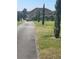 Long paved driveway leading to a stunning home with well-manicured landscaping at 8250 Cherry Lake Rd, Groveland, FL 34736