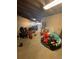 Unfinished garage, filled with personal items and space for parking a golf cart at 8250 Cherry Lake Rd, Groveland, FL 34736
