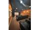 Spacious home theater with leather seating, projector screen, and sconce lighting at 8250 Cherry Lake Rd, Groveland, FL 34736