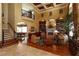 Spacious living room with a fireplace, built-in bookshelves, and staircase to the second level at 8250 Cherry Lake Rd, Groveland, FL 34736