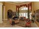 Grand living room featuring high ceilings, tall windows with decorative curtains and tile flooring at 8250 Cherry Lake Rd, Groveland, FL 34736