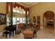 Spacious living room featuring floor to ceiling windows and an upright piano at 8250 Cherry Lake Rd, Groveland, FL 34736