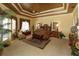 Spacious main bedroom with a tray ceiling, luxurious decor, and large windows at 8250 Cherry Lake Rd, Groveland, FL 34736