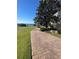 Brick paver walkway that leads to lakefront yard with mature trees and landscaping at 8250 Cherry Lake Rd, Groveland, FL 34736