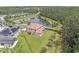 Aerial view of house with large backyard, outlined property lines, and nearby pond in community at 8478 Elba Isle Ct, Windermere, FL 34786