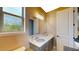 This bathroom has a tile shower with glass enclosure, vanity, grey cabinets, and a decorative sink at 8478 Elba Isle Ct, Windermere, FL 34786