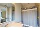 Neutral bathroom with bright white vanity, and a bathtub with a decorative blue striped shower curtain at 8478 Elba Isle Ct, Windermere, FL 34786