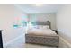 This bedroom features a tufted headboard, plush bedding, and lots of natural light from the exterior windows at 8478 Elba Isle Ct, Windermere, FL 34786