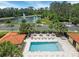 Enjoy the community pool area with tables, lounge chairs, and a view of the pond and fountain at 8478 Elba Isle Ct, Windermere, FL 34786