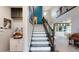 Grand entryway with white staircase and blue accent wall, leading to an open-concept living space at 8478 Elba Isle Ct, Windermere, FL 34786