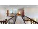 Upstairs hallway with decorative dark wood railing, and access to various rooms at 8478 Elba Isle Ct, Windermere, FL 34786
